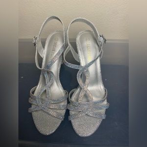 Brand new. Never worn. Glittery silver heels